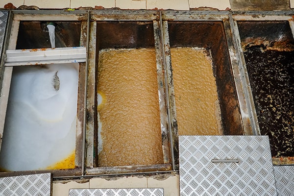 signs that indicate a grease trap is in need of maintenance include slow draining sinks, foul odors, and grease buildup in the drain